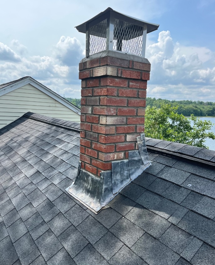 Brick chimney with a new chimney cap and flashing